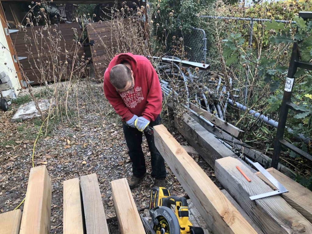 BJ cuts timbers for the Model Unit's Deck